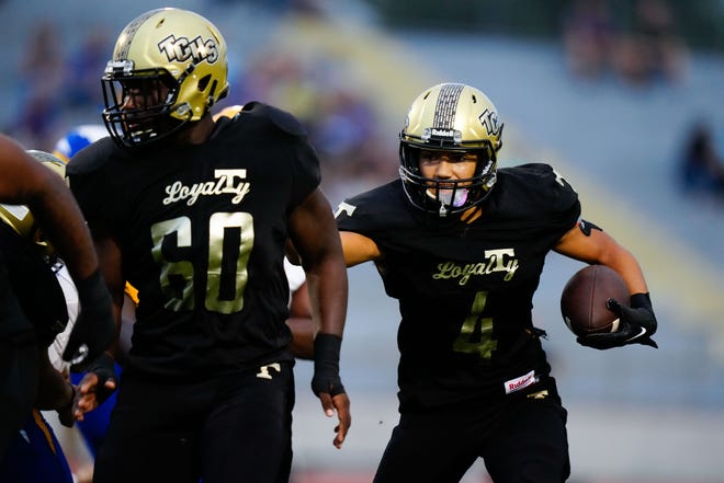 Treasure Coast High School’s quarterback George Roberts (4) runs the ball against Martin County High School in a high school football game on Friday, Sept. 16, 2022 at Lawnwood Stadium in Fort Pierce. Treasure Coast won 28-7 after the game was shortened due to weather.
