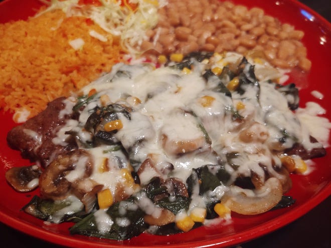 The steak Jalisco is a flame-broiled skirt steak with grilled fresh roasted poblano peppers, mushrooms, onions, corn and spinach with jack cheese is served with rice and whole white beans