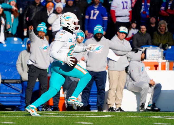Jan 15, 2023; Orchard Park, NY, USA; Miami Dolphins cornerback Xavien Howard (25) intercepts a pass against the Buffalo Bills during the first half in a NFL wild card game at Highmark Stadium. Mandatory Credit: Gregory Fisher-USA TODAY Sports