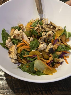 The Pacific Rim salad is grilled chopped tasty chicken atop a bed of crispy chopped romaine, with snow peas, tiny, sweet mandarin orange slices, and crunchy wontons, tossed in a sweet and tangy Asian sesame dressing.