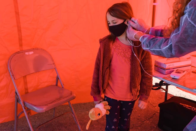 A student receives a hearing test at school in New Mexico. Some people are learning that they've lost their hearing when masks became ubiquitous in the pandemic.