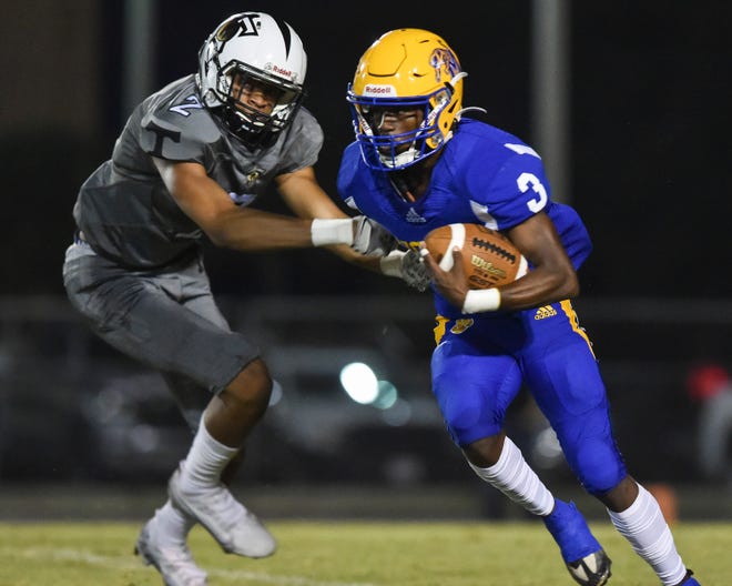 Martin County's Denzel Alexander (3) breaks free from Treasure Coast's Omari Kinsler (2) during the first quarter in a Region 3-4S quarterfinal football game, Friday, Nov. 11, 2022, in Stuart. Treasure Coast won 35-7.