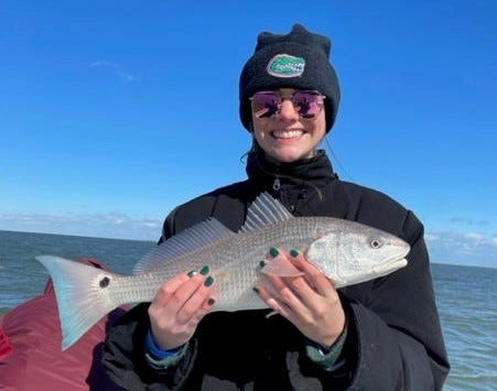 Shannon Stack with a redfish she caught and released while fishing the Mosquito Lagoon with Capt. Joe Catigano.