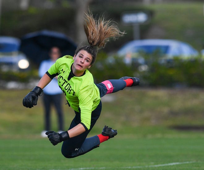 Victory Christian Academy senior goalkeeper Alaina Fountain attempts to block a shot by the Pine School in a high school girls soccer Region 2-2A quarterfinal on Tuesday, Feb. 7, 2023, in Hobe Sound.