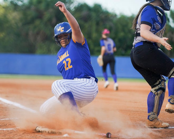 John Carroll Catholic's Isabella Ramirez makes a run as she slides safely into home plate during a softball game against Sebastian River on Wednesday, March 30, 2022, at Sebastian River High School. Sebastian River won 12-8.