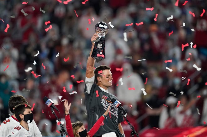 FILE - Tampa Bay Buccaneers quarterback Tom Brady holds up the Vince Lombardi trophy after defeating the Kansas City Chiefs in the NFL Super Bowl 55 football game, Feb. 7, 2021, in Tampa, Fla. Brady, the seven-time Super Bowl winner with New England and Tampa Bay, announced his retirement from the NFL on Wednesday, Feb. 1, 2023 exactly one year after first saying his playing days were over, by posting a brief video lasting just under one minute on social media. (AP Photo/Ashley Landis, File)