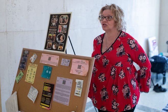 Angie Hatfield stands at her table setup in the Florida Capitol to speak with people about drug usage Tuesday, Jan. 24, 2023. She brings naloxone, the drug that reverses opioid overdoses and fentanyl test strips.