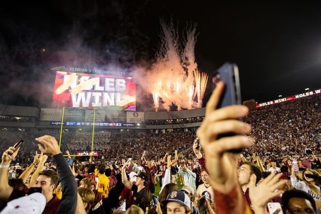 Members of the Florida State Seminoles football team and fans celebrate the team’s victory over the Florida Gators at Doak Campbell Stadium on Friday, Nov. 25, 2022.