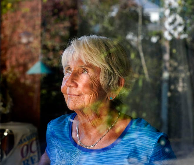 Nicki Campbell, 81, of Stuart, sits for a portrait as she looks at her backyard garden, Wednesday, Nov. 23, 2022. Campbell was a Master Gardner for many years, but after her husband George Arthur "Art" died in 2015, she decided it was a lonesome hobby and began a journey to the beach where she forged a community of lifeguard, surfing and jogging friends. "When I started walking ... the momentum built, my spirit built," said Campbell. "The happiness I felt when I would get up in the morning and just know I was headed to the beach."