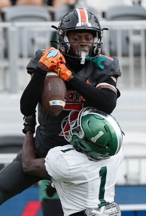 Cormani McClain (7) of Lakeland breaks up a pass intended for Kenyon Sears (1) of Venice in first half of the Class 4S state championship game at DRV PNK Stadium, Saturday, Dec. 17, 2022 in Fort Lauderdale.