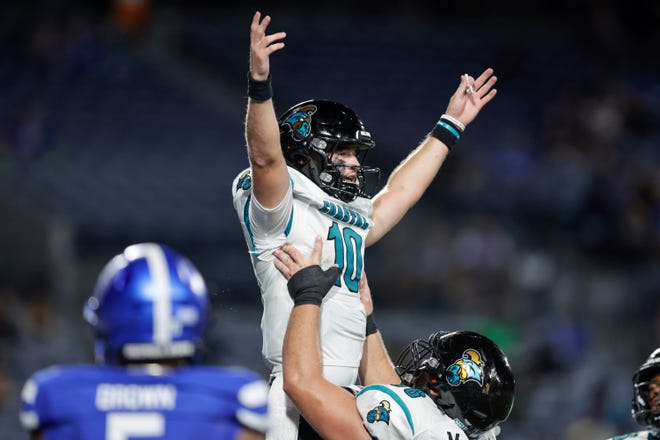 Coastal Carolina quarterback Grayson McCall (10) is lifted in the air by offensive lineman Will McDonald, bottom, after scoring a touchdown against Georgia State on Sept. 22, 2022, in Atlanta.