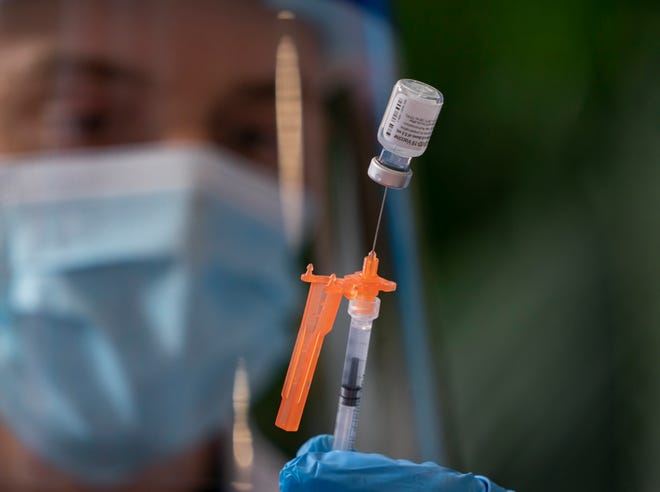 Christoffer Knight prepares a dose of the Pfizer COVID-19 vaccine during "Play date to vaccinate" for pregnant women to get vaccinated at Palm Beach Children's Hospital at St. Mary's Medical Center in West Palm Beach, Florida on August 31, 2021.