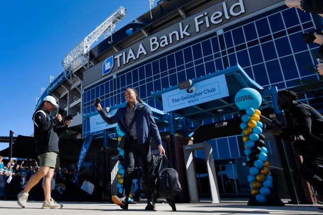 Jacksonville Jaguars cornerback Gregory Junior (34) waves as he leaves TIAA Bank Field Friday morning to head to Kansas City. Hundreds of Jacksonville Jaguar fans waited outside the West entrance of TIAA Bank Field Friday morning, January 20, 2023 to cheer on the team as they headed to their cars to drive to the airport for their flight to Kansas City to play their AFC divisional round game against the Chiefs on Saturday.