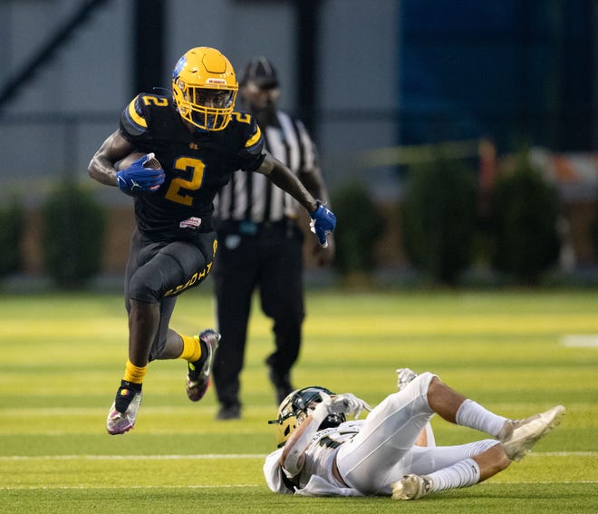 Rickards wide receiver Rico Watkins (2) leaps over a defender as he sprints down the field. The Rickards Raiders hosted the Fleming Island Golden Eagles at Gene Cox Stadium on Friday, Sept. 2, 2022.