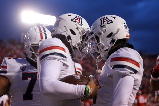 Nov 5, 2022; Salt Lake City, Utah, USA; Arizona Wildcats quarterback Jayden de Laura (center) celebrates scoring a touchdown with teammates in a game against the Utah Utes during the first quarter at Rice-Eccles Stadium. Mandatory Credit: Rob Gray-USA TODAY Sports