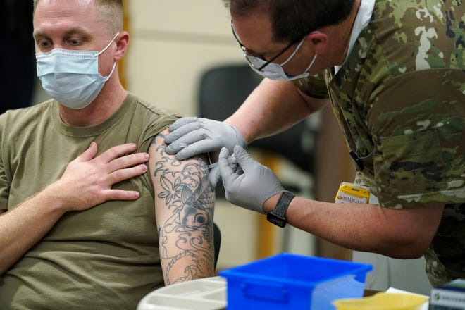 Staff Sgt. Travis Snyder receives the  the Pfizer COVID-19 Madigan Army Medical Center at Joint Base Lewis-McChord in Washington state,