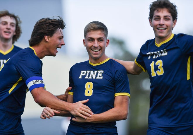 The Pine School's Thomas Duffin (8) celebrates his goal with teammates against St. Edward's in a boys soccer District 8-2A championship, Wednesday, Feb. 1, 2023, in Hobe Sound. The Pine School won 3-0.