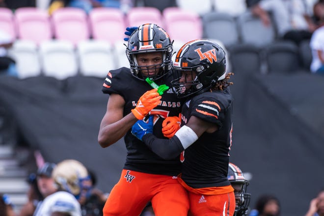 Lake Wales cornerback Philipp Davis (5) celebrates a second quarter interception with teammate Jaremiah Anglin Jr. (0) during the first half of the Class 3S football state championship game between Lake Wales and Mainland at DRV PNK Stadium on Friday, December 16, 2022, in Fort Lauderdale, FL. Final score, Lake Wales, 32, Mainland, 30.