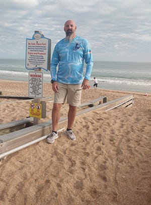 In better times, that railing at Dustin Smith's ankle would be alongside his hip. The pedestrian ramp at Bethune Beach Park remains a sandbox, three months after Nicole.