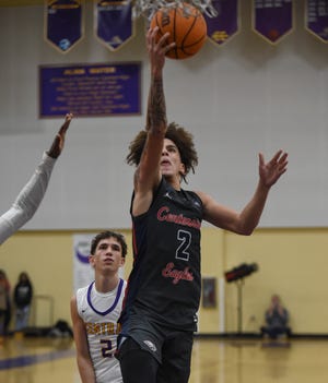 Ty Owens (center), of St. Lucie West Centennial, makes a layup in the final minutes against Fort Pierce Central inside Central's gym on Friday, Jan. 27, 2023, in Fort Pierce. Centennial won 65-56.