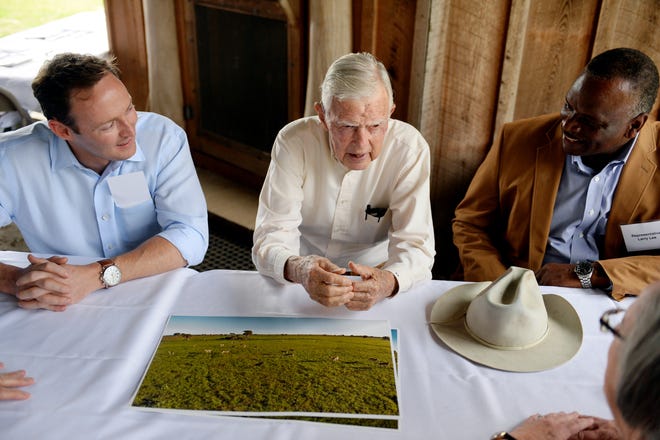 U.S. Rep. Patrick Murphy, D-Jupiter, (left) and State Rep. Larry Lee Jr., D-Port St. Lucie, (right) listen in Thursday as Bud Adams speaks to a group gathered for the announcement of the completion of the first set of conservation easements to be added to the Everglades Headwaters National Wildlife Refuge and Conservation Area. Ranch property owned by Adams in Osceola County is part of the 5,300-acre easement purchase. He is one of five ranch owners who are part of the $12.5 easement purchase.