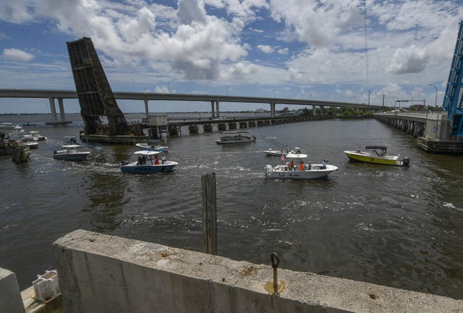 Boat traffic travels through the open railroad bridge (left) and the Old Roosevelt draw bridge in the St. Lucie River on Monday, July 25, 2022, in Stuart. For more than an hour boaters protested for keeping he 100-year-old railroad drawbridge open for 30 minutes of every hour of future Brightline train traffic.