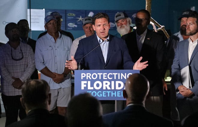Florida Governor Ron DeSantis, flanked by public officials and boat captains from Naples and Jensen Beach, holds a press conference at the Cox Science Center and Aquarium Wednesday in West Palm Beach. DeSantis touted his veto of water legislation and another $1.2B he’s set aside for the Everglades and Florida water goals.