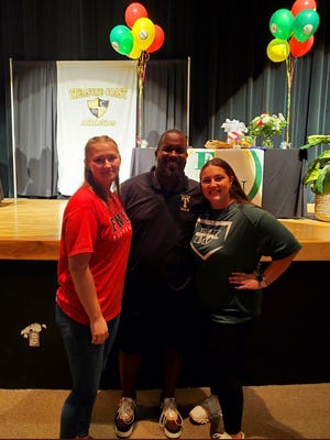 Treasure Coast softball seniors Brylea Rusler and Briana Musso celebrate their signings to Florida National and Webber International with Titans head coach Floyd McNair on Friday, Feb. 10, 2023.