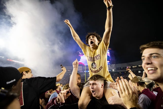 Members of the Florida State Seminoles football team and fans celebrate the team’s victory over the Florida Gators at Doak Campbell Stadium on Friday, Nov. 25, 2022.