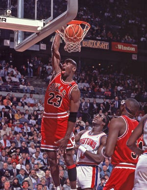 Chicago Bulls guard Michael Jordan dunks against the Detroit Pistons at the Palace of Auburn Hills.