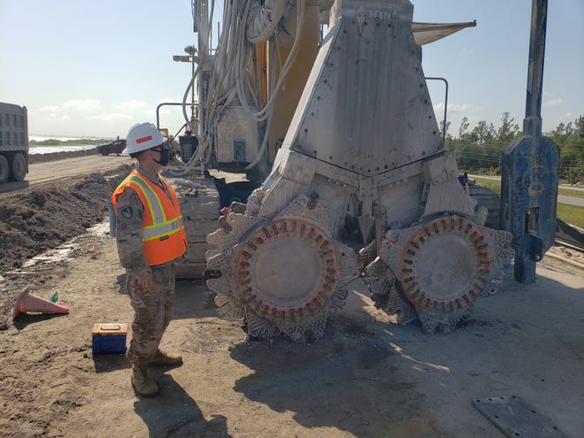 Army Corps of Engineers Jacksonville District Commander Col. Andrew Kelly observes the cutting head of the machinery being used April 14, 2021 to install a cut-off wall deep inside the Herbert Hoover Dike near Clewiston.