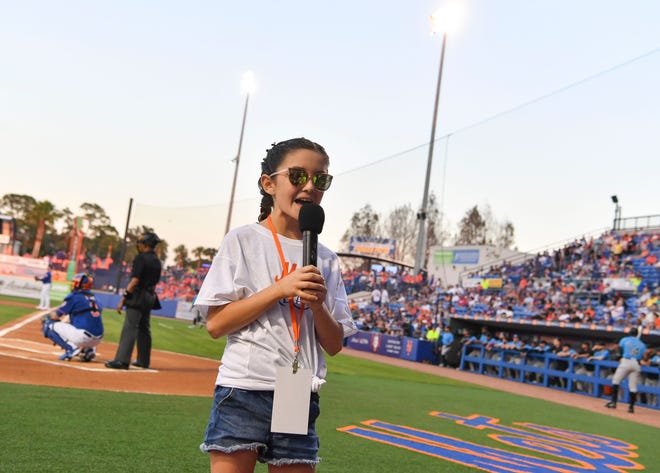 Natalia Lasasso, 10, of Port St. Lucie, announces "play ball" as the spring training season home opener against the Miami Marlins begins, Saturday, Feb. 25, 2023, in Port St. Lucie. Lasasso has Cystic Fibrosis and is part of the Make-a-Wish program. She's still waiting for her wish, a trip to Hawaii, to come true. But she was able to live out her biggest sports dream Saturday, thanks to local Dianne Heard. Heard and her husband have been volunteering with Make-A-Wish for 18 years to give kids the opportunity to say the 'play ball' announcement at Clover Park.