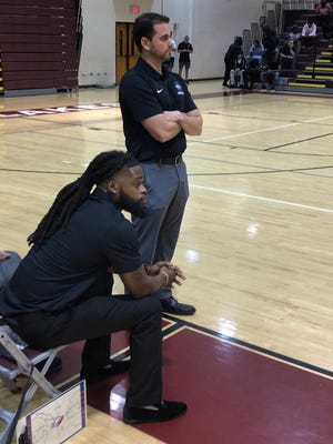 Centennial coach Chris Carannante (standing) watches his team set up the offense against Jupiter on Wednesday night in West Palm Beach.