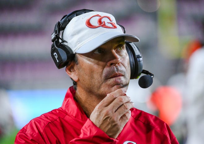 Gibbons head coach Matthew DuBuc looks at the scoreboard during the Class 4A State Championship game between Cardinal Gibbons and Cocoa Beach at DRV PNK Stadium in Fort Lauderdale, FL., on Thursday, December 16, 2021. Final score, Gibbons 21, Cocoa, 19.