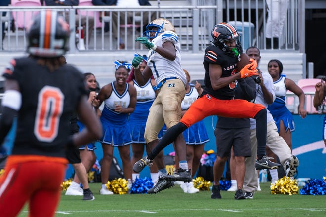 Lake Wales cornerback Philipp Davis (5) intercepts a pass intended for Mainland running back Ajai Harrell (1) in the second quarter of the first half of the Class 3S football state championship game between Lake Wales and Mainland at DRV PNK Stadium on Friday, December 16, 2022, in Fort Lauderdale, FL. Final score, Lake Wales, 32, Mainland, 30.