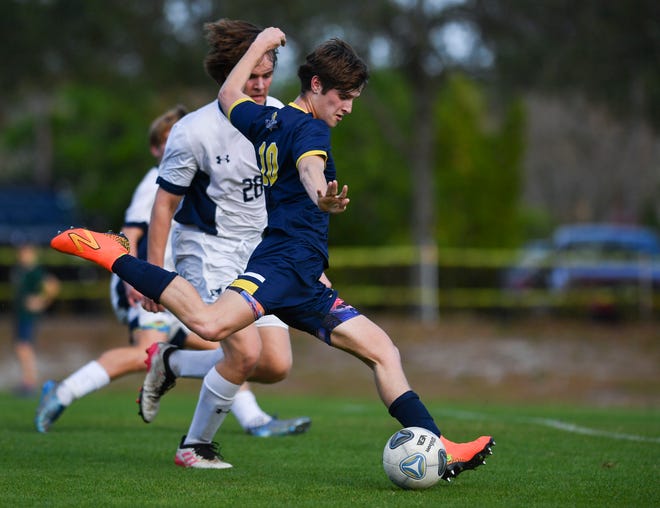 The Pine School's Jaxon McAlees (10) takes a shot against St. Edward's in a boys soccer District 8-2A championship, Wednesday, Feb. 1, 2023, in Hobe Sound. The Pine School won 3-0.