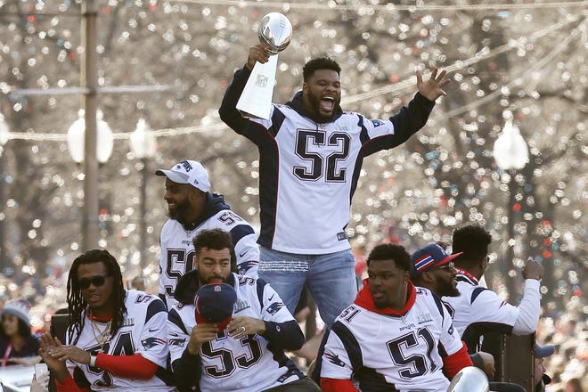 New England Patriots' Elandon Roberts (52) rides a duck boat during the Patriots parade through downtown Boston, Tuesday, Feb. 5, 2019, to celebrate their win over the Los Angeles Rams in NFL Super Bowl 53 football game in Atlanta. (AP Photo/Michael Dwyer)