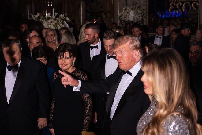 Former President Donald Trump and his wife, Melania Trump, are seen inside the Mar-A-Lago ballroom on New Years Eve on Saturday, December 31, 2022, in Palm Beach.