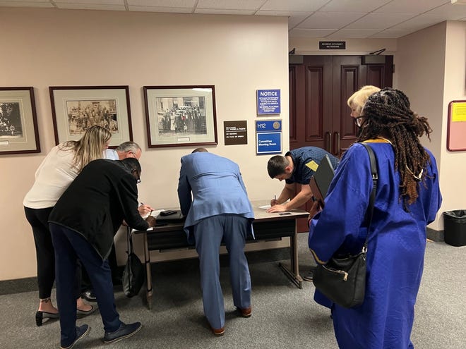 Classroom teachers fill out speaker cards to address lawmakers when  the PreK-12 Committee took up a universal voucher plan