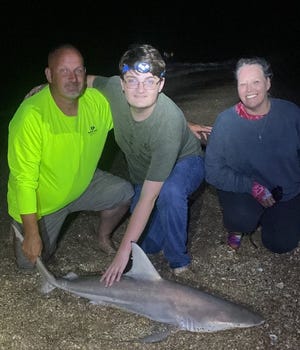 The Jehnsen family, from Michigan, with a blacktip shark caught during an outing with NSB Shark Hunters.