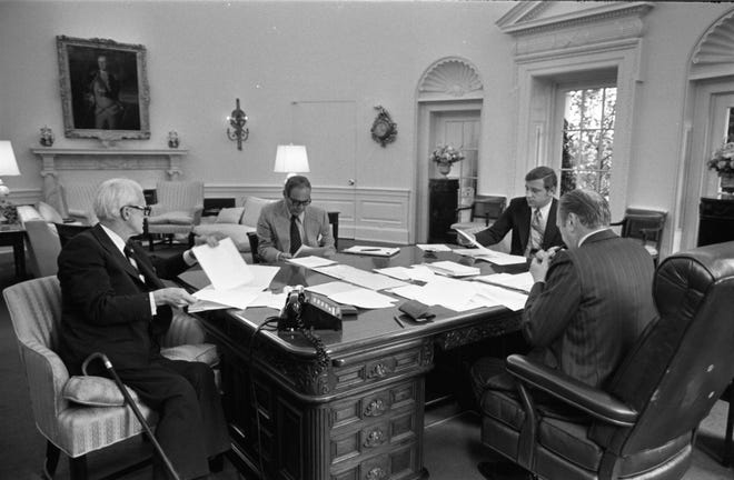 In this Sept. 5, 1974, photograph, President Ford, far right, Benton Becker, second from right, discuss the u0022Nixon situationu0022 with Chief of Staff Alexander Haig and White House lawyer Philip Buchen.