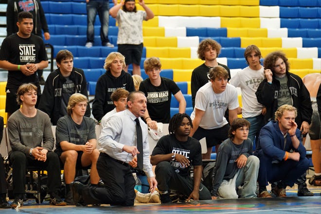 Jensen Beach wrestling head coach Tom McMath and his team watch Gian Ortiz compete during Saturday's FHSAA Duals State Championships on Jan. 21, 2023 at Osceola High School in Kissimmee. The Falcons defeated Zephyrhills Christian 57-12 in the final to win the 1A state title for the second year in a row.