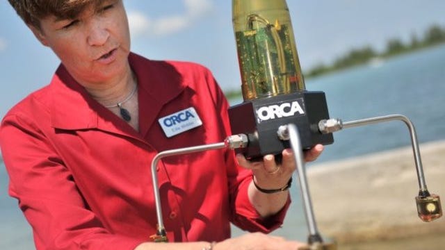 Senior scientist Edith Widder of the Ocean Research & Conservation Association explains the function of the Kilroy water-monitoring device she is holding during a media event in 2011. The units were deployed in certain parts of the Indian River Lagoon.