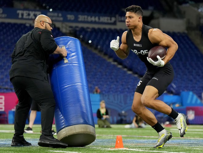 UCLA running back Zach Charbonnet goes through positional drills.