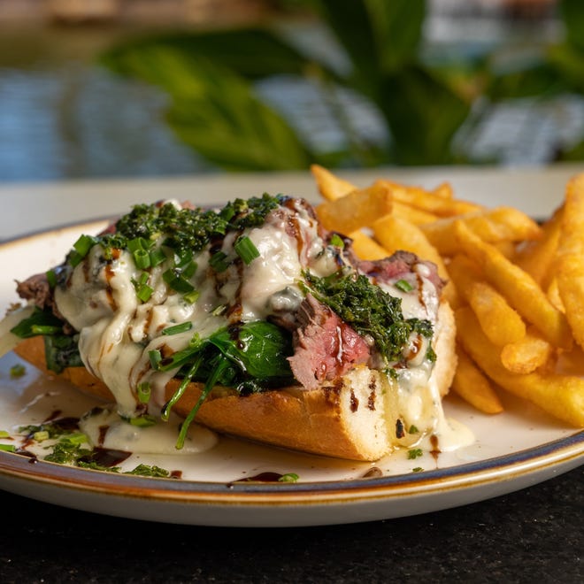 Oak & Ember Steakhouse, which opened Feb. 24 in downtown Stuart, features an open-faced steak sandwich with sliced sirloin, caramelized onions, spinach, salsa verde aioli, melted blue cheese, balsamic glaze and red chimichurri on ciabatta bread.