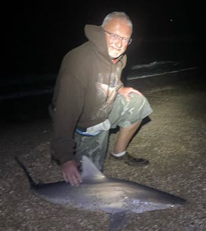 Jimbo, from Illinois, with a blacknose shark brought to shore with the help of NSB Shark Hunters.