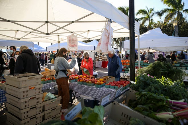 Locals and tourists enjoy a variety of vendors offering a diverse selection of foods, plants, spices and more during the Downtown Fort Pierce Farmers' Market at Marina Square on Saturday, Jan. 9, 2021.