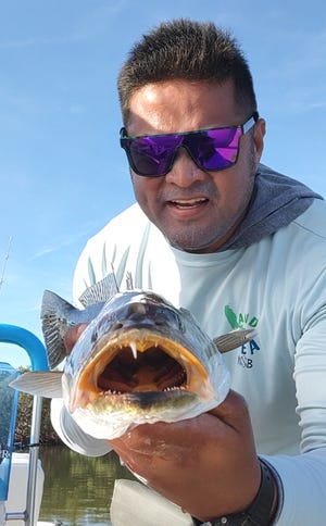 GJ Realin with a seatrout he caught in the Indian River. It's down one of its upper front teeth, but the one remaining is a dandy.