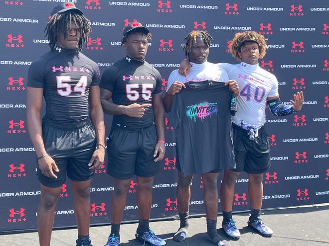 Linebackers TJ Alford (54) and Rodney Hill (55) and running backs Stacy Gage and Khalid Campbell (40) pose at the Under Amour Next Series Camp at West Orange High School on Sunday. Alford, Hill and Campbell were MVPs in their position groups. Gage was invited to the All-America Game.