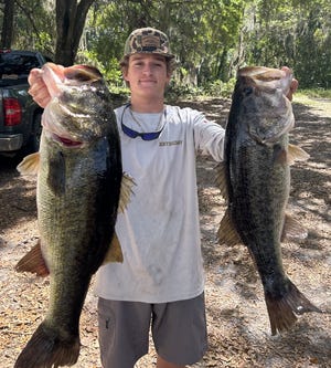 Forget the gym. Thomas Delaney is doing curls here with a pair of largemouth bass plucked from the St. Johns River, which is world famous for such gifts.